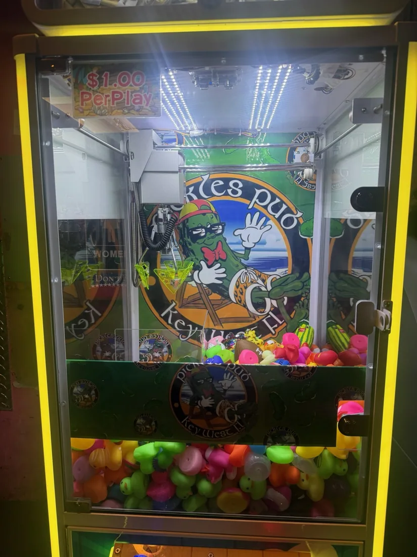 Pickles Pub branded claw machine with printed front panel
