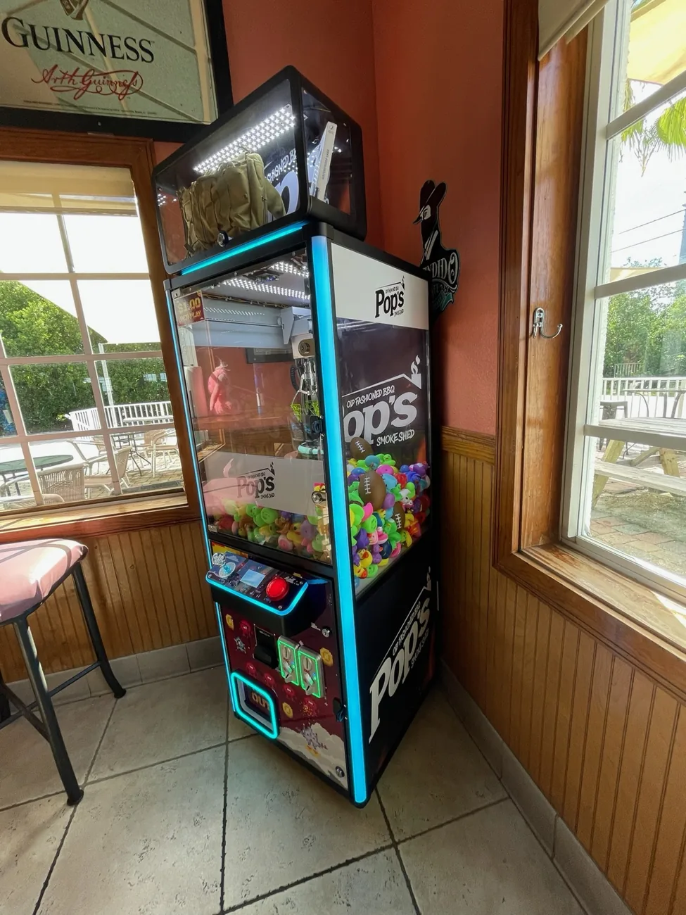 Pops BBQ branded claw machine photographed at the venue