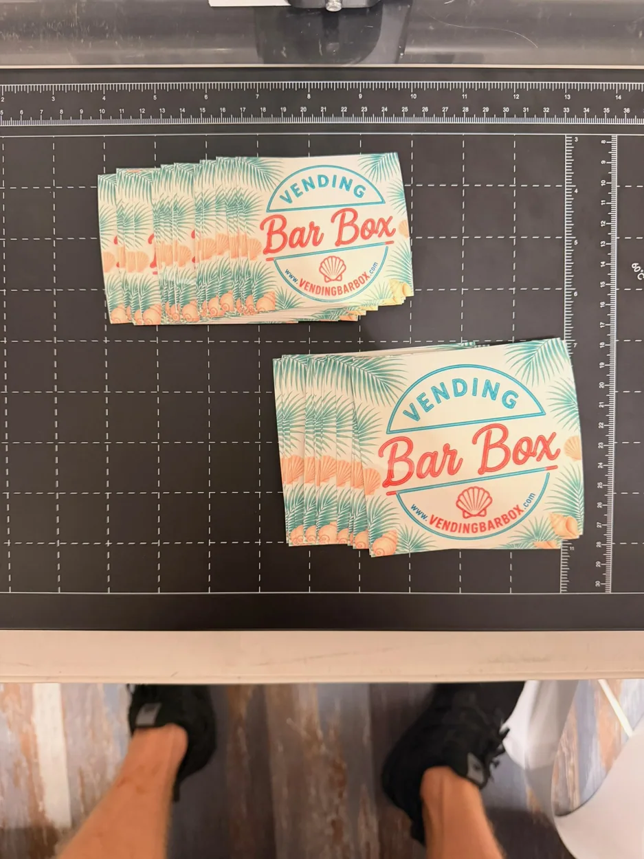 Freshly printed Vending Bar Box decals arranged on a cutting mat